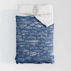 a bed with blue and white fish on it