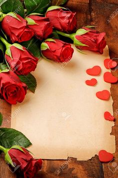 red roses and paper with hearts on wooden background stock photo 549782