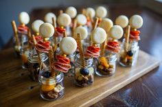 small jars filled with food on top of a wooden table