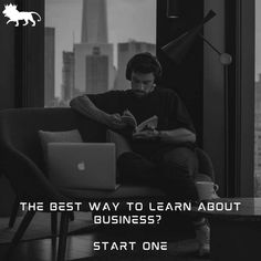 a man sitting on top of a couch in front of a laptop next to a window