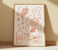 an art print with food and wine on it in front of a wall mounted frame