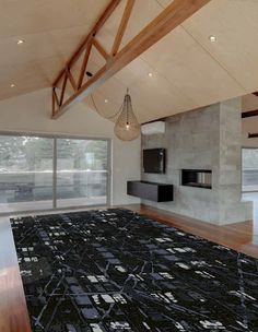 an empty living room with wood floors and large windows