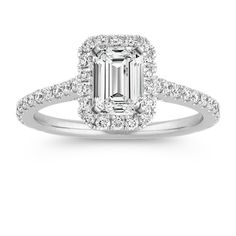 an engagement ring with a princess cut diamond in the center and pave set shoulders