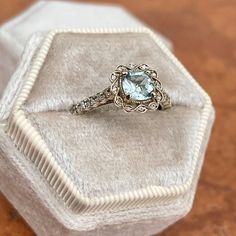 Estate/ Vintage 14KT white gold ring with genuine, rounded, square, cushion-cut aquamarine + diamond halo and accents. Pale, blue color aquamarine with yellow/green undertones. Beautiful stone + well faceted. Size 7 Weight: 3.2 grams Genuine, rounded square cushion cut Aquamarine measures: 6mm x 6mm 1.00+ carat genuine aquamarine .30 CT natural diamonds; SI1/2 clarity (22) diamonds on the shank (12) diamonds on the scroll, filigree halo Not stamped 14K, but fully tested Gold is patina'd and we l Stone Well, Pale Blue Color, Rounded Square, Filigree Ring, White Gold Ring, Diamond Halo, Cushion Cut, White Gold Rings, Halo Diamond