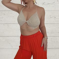 Introducing the Two-Way Crochet Cropped Top from Rita Rosa Brazilian Beachwear. Handcrafted with passion, this top embodies the elegance and versatility of sustainable fashion. Available in earthy beige and vibrant red, it flatters your shape and accentuates your style. Each piece is meticulously handmade, ensuring uniqueness. It features eco-friendly materials, padded cups for comfort and support, a fashionable halter neckline, and delicate lace straps. The innovative two-way design allows vers Fitted Beige Crochet Top For Party, Beige Fitted Triangle Top, Beige V-neck Crop Top For The Beach, Beige Triangle Crochet Top For Summer, Beige Open Knit Crop Top For Summer, Beige Stretch Top With Crochet Lace, Beige Stretch Crochet Top For The Beach, Beige Triangle Crop Top, Beige Fitted Crochet Crop Top