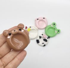 there is a hand holding three small toy animals