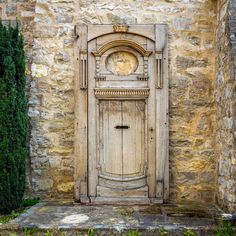 an old wooden door in front of a stone building