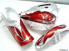 three red and silver items sitting on top of a white table