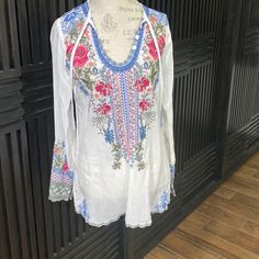 Great Johnny Was White Embroidered Tunic. V Neck Has Three Functional Buttons And A Tie Making It Very Versatile. About 19 Across And 28 Length From Shoulder. Great Summer Top That Would Be Phenomenal With Jean Shorts And A Wedge Sandal. Floral Embroidered Long Sleeve Top For Vacation, Long Sleeve Floral Embroidered Top For Vacation, Multicolor Embroidered Long Sleeve Top For Vacation, Long Sleeve Embroidered Top For Vacation, White Embroidered Floral Top For Beach, Multicolor Embroidered Long Sleeve Beach Top, White Long Sleeve Embroidered Top With Floral Print, White Embroidered Floral Top For Vacation, White Long Sleeve Top With Floral Embroidery