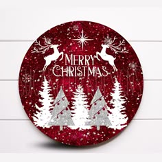 a red and white christmas ornament with trees