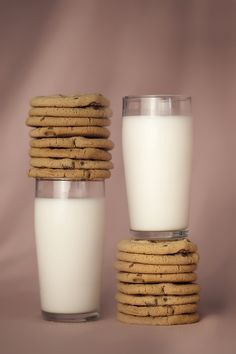 a stack of cookies next to a glass of milk