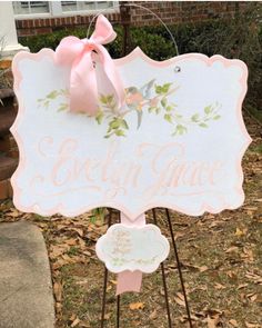 a sign with a pink bow on it