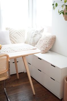 a room with a table and some drawers