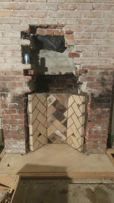 a brick fireplace in the process of being remodeled