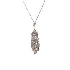 This Art Deco filigree pendant necklace is crafted in polished 14 karat white gold, reflecting the intricate artistry of the era. The pendant features three single-cut diamonds, each with SI1 clarity and H color grade, weighing .03 carats and measuring 1.25 mm. The diamonds are arranged to catch the light and add sparkle to the piece. The filigree detailing and milgrain accents enhance its vintage charm. This necklace is ideal for those who appreciate antique jewelry or fine craftsmanship, makin Formal Art Deco Necklaces With Single Cut Diamonds, Evening Platinum Diamond Cut Necklace, Evening Platinum Necklace With Diamond Cut, Platinum Diamond Cut Necklace For Evening, Art Deco Diamond Necklace In White Gold, Art Deco Diamond White Necklace For Formal Occasions, Evening White Gold Sterling Silver Diamond Necklace, Art Deco Oval Diamond Necklaces, Art Deco Oval Diamond Necklace