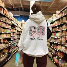 a person wearing a hoodie in a grocery store with the words go your team on it