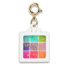 a square keychain with the words sparkle and hearts in different colors on it