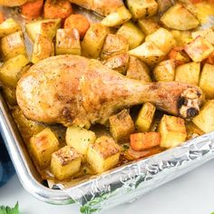 a roasting pan with chicken, potatoes and parsley on the side for garnish