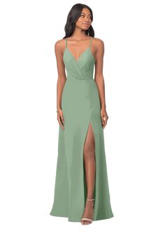 a woman in a long green dress with a slit down the side and one leg