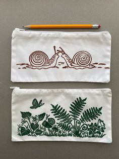 two pencil cases with designs on them