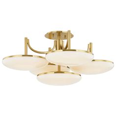 three light brass ceiling fixture with white glass shades and an oval design on the bottom