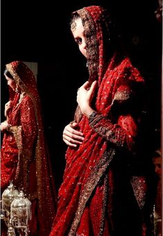 two women dressed in red standing next to each other