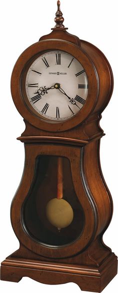 an old fashioned grandfather clock hanging on the wall with pendulums and hands in brown wood