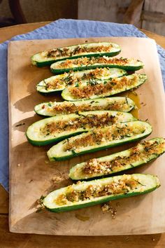 sliced zucchini on a cutting board with seasoning sprinkled on top