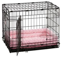 a dog crate with a pink blanket inside