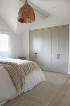 a bedroom with white walls and beige carpet