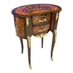 an ornately decorated table with drawers