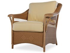 a wicker chair with beige cushions on an isolated white background