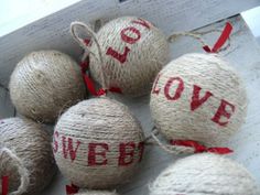 several burlocks with love written on them are tied to a white wooden box