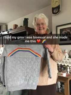 an older woman holding up a sweater with a rainbow on it and the words i told my grandma i was bisexual and she made me this