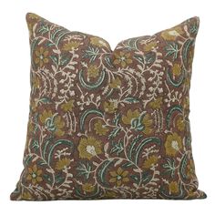 a brown pillow with green and yellow flowers on it