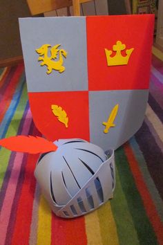 a paper cut out of a helmet on top of a striped tablecloth covered floor