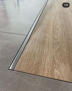 a close up of a wooden floor with metal trimmings on the edge and bottom