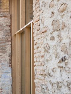 an open window on the side of a brick building