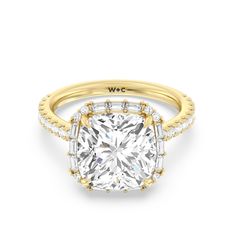 a yellow gold ring with a cushion cut diamond in the center