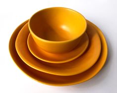 four yellow plates stacked on top of each other