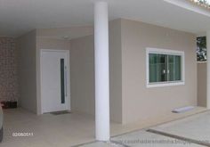 an empty house with white pillars and windows