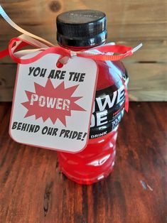 a bottle with a tag that says you are the power behind our pride