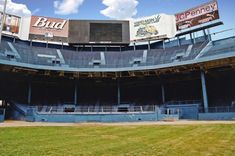 an empty stadium filled with lots of seats and banners on the side of the building