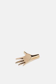 a gold fork brooch on a white background