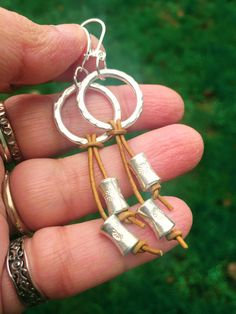 This gorgeous pair of earrings feature hand-rolled silver beads strung in natural mustard yellow leather cords and Hill Tribe silver rings and sterling silver hooks.  The silver is bright and shiny at the moment but as is the case with silver, with exposure to the atmosphere, it will obtain a lovely patina and the embossed patterns will be highlighted over time. If you do not like the patina, it can always be polished back to it's bright and shiny self. The earrings are approx. 3 inches long and approx. 1 inch wide at the widest point.  Free shipping within USA. -------------- Sterling Silver Hoop Earrings, Dangle Earrings, Boho Earrings, Delicate Earrings, Statement Earrings, Long Silver Earrings, Leather Earrings Silver Sterling Hoop Earrings With Dangling Beads, Silver Jewelry With Dangling Beads For Everyday, Bohemian Sterling Silver Earrings With Dangling Charms, Adjustable Dangle Wrap Earrings For Jewelry Making, Artisan Sterling Silver Jewelry With Dangling Beads, Adjustable Nickel-free Dangle Wrap Earrings, Nickel-free Dangle Wrap Earrings, Sterling Silver Linear Earrings With Dangling Beads For Gift, Silver Hoop Earrings With Dangling Beads For Gift