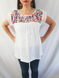 Beautiful blouse made by hand in Chiapas, Mexico creating fashion and art. This is a beautiful blouse with colorful flowers and short sleeve. Very comfortable, Goes great with jeans, leggings, skirt, shorts... Each piece is unique and handmade with dedication and taking care of every detail achieving the best quality in our products, which is why it makes it beautiful and unique each of the embroidered flowers. You can buy the blouse with the earrings Colors and flowers may vary depending on the White Short Sleeve Top With Embroidered Hem, White Embroidered Hem Top With Short Sleeves, Bohemian Embroidered Summer T-shirt, Bohemian Embroidered Short Sleeve Top For Summer, Summer White Blouse With Embroidered Neckline, White Summer Blouse With Embroidered Neckline, White Embroidered Blouse For Summer, White Embroidered Neckline Blouse For Summer, White Embroidered Beach Shirt