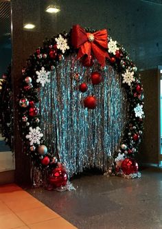 a christmas wreath decorated with red and silver ornaments