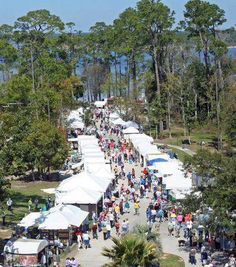 an aerial view of people walking around tents