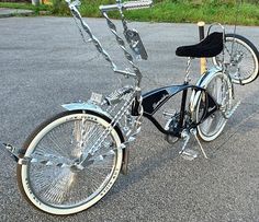 a black and silver bicycle parked next to a wooden pole