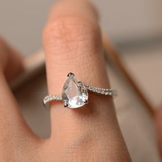 Natural white topaz ring pear shaped engagement ring silver | Etsy Diamond White Teardrop Ring For Promise, Pear Shaped Rose Cut Diamond Ring For Proposal, Pear-shaped Rose Cut Diamond Rings For Proposal, Pear-shaped Rose Cut Diamond Proposal Ring, Teardrop Rose Cut Diamond Promise Ring, Silver Pear-shaped Ring With Halo Setting, Teardrop Rose Cut Diamond Proposal Ring, Silver Teardrop Wedding Ring With Halo Setting, Teardrop Diamond White Jewelry For Proposal